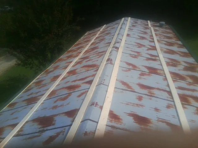 Rusted metal roof panels with new wood purlins before replacement — Storm Damage Roof Repair in Ionia by Roofing Brothers